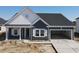 Inviting single-story home with a spacious driveway leading to an attached garage, and a covered front entry at 1013 Jase Dr., Longs, SC 29568