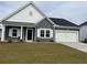 Charming single-story home with a well-manicured lawn, attached garage, and a welcoming front entrance at 1013 Jase Dr., Longs, SC 29568