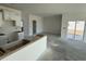 Open concept kitchen with modern white cabinetry and a view to the bright living area at 1013 Jase Dr., Longs, SC 29568