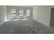 Bright, unfinished living room with large windows, allowing ample natural light to fill the space at 1013 Jase Dr., Longs, SC 29568