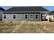 Rear view of the house showcasing the siding, windows, and covered back porch at 1013 Jase Dr., Longs, SC 29568