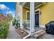 Exterior view of the home's entrance showcasing the front porch and colorful landscaping at 1045 Means Circle, Myrtle Beach, SC 29577