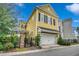 Exterior elevation of a yellow, two-story home with a garage and brick-paved front walk at 1045 Means Circle, Myrtle Beach, SC 29577