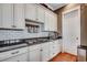 Charming kitchen showcasing white cabinetry, granite counters, and subway tile backsplash at 1045 Means Circle, Myrtle Beach, SC 29577