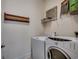 Functional laundry room with modern washer and dryer units and shelving at 1045 Means Circle, Myrtle Beach, SC 29577