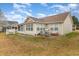 Backyard of home with screened in porch, patio, grill, and outdoor furniture at 105 Sebring Ln., Myrtle Beach, SC 29588