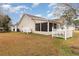 Home's backyard featuring a screened-in porch and a white picket fence at 105 Sebring Ln., Myrtle Beach, SC 29588