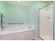 Well-lit bathroom offering a soaking tub, walk-in shower, and grab bar for accessibility at 105 Sebring Ln., Myrtle Beach, SC 29588