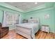 Comfortable bedroom with a decorative tray ceiling, wood floors, and a large window at 105 Sebring Ln., Myrtle Beach, SC 29588