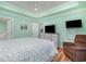 Inviting bedroom with a tray ceiling, television, and view to the ensuite bath at 105 Sebring Ln., Myrtle Beach, SC 29588