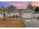 Charming home with a well-maintained lawn, a one-car garage, and a welcoming front porch at 105 Sebring Ln., Myrtle Beach, SC 29588