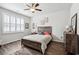 Bedroom with ceiling fan features a window with white shutters and wood-look flooring at 1061 Sennema Circle, Myrtle Beach, SC 29588