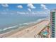 Panoramic aerial view of beach, ocean, condos and community with palm trees and pools at 107 S Ocean Blvd. # 1706, Myrtle Beach, SC 29577