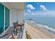 Balcony overlooking beach, featuring seating and partial view of a pier at 107 S Ocean Blvd. # 1706, Myrtle Beach, SC 29577