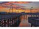 Scenic boardwalk view at twilight, featuring vintage-style lampposts against a colorful, picturesque sunset sky at 107 S Ocean Blvd. # 1706, Myrtle Beach, SC 29577