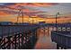 A beautiful shot of a wooden boardwalk at sunset with colorful skies reflecting on the water at 107 S Ocean Blvd. # 1706, Myrtle Beach, SC 29577