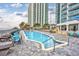 Outdoor pool and lounging area with beach access and seating at resort property and modern building at 107 S Ocean Blvd. # 1706, Myrtle Beach, SC 29577