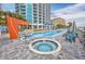 Relaxing outdoor pool and hot tub with lounge chairs and modern architectural building at 107 S Ocean Blvd. # 1706, Myrtle Beach, SC 29577