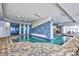 Indoor pool area with natural lighting, tile accent wall, modern design, and ample seating at 107 S Ocean Blvd. # 1706, Myrtle Beach, SC 29577