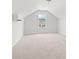 Cozy carpeted bedroom featuring vaulted ceiling and bright window with neighborhood views at 119 Old Chimney Ln, Conway, SC 29526