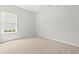 Well-lit bedroom with neutral carpet and a window providing natural light and neighborhood views at 119 Old Chimney Ln, Conway, SC 29526