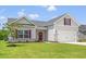 Beautiful one-story home with a two-car garage, lush green lawn, and attractive exterior details at 119 Old Chimney Ln, Conway, SC 29526