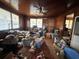 A living room packed with boxes and clutter, showcasing hardwood floors and a ceiling fan at 1264 Harrelson Dr., Longs, SC 29568