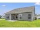 The backyard features gray siding and a small covered patio at 127 Old Chimney Ln, Conway, SC 29526
