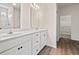 Bright bathroom features double sinks, white cabinetry, and vinyl flooring at 127 Old Chimney Ln, Conway, SC 29526
