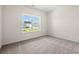A cozy bedroom featuring neutral carpet and paint with a window offering ample natural light at 127 Old Chimney Ln, Conway, SC 29526
