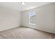 This bedroom features neutral carpet and paint with a large window offering ample natural light at 127 Old Chimney Ln, Conway, SC 29526