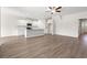 Bright open-concept living room with hardwood floors and white kitchen cabinets at 127 Old Chimney Ln, Conway, SC 29526