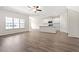 Bright open-concept living room with hardwood floors and large windows overlooking neighborhood at 127 Old Chimney Ln, Conway, SC 29526