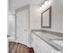 Modern bathroom featuring a granite countertop, white cabinets, and wood-look flooring at 130 Palm Dr., Loris, SC 29569