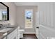 Modern bathroom featuring granite countertop and sleek white cabinetry at 130 Palm Dr., Loris, SC 29569