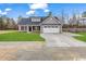 Charming single-Gathering home with gray siding, black shutters, and a well-manicured lawn and an attached two-car garage at 130 Palm Dr., Loris, SC 29569