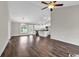 Spacious living room featuring hardwood floors, bright lighting, and an open floor plan leading to a modern kitchen at 130 Palm Dr., Loris, SC 29569