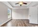 Bright main bedroom, featuring a ceiling fan, hardwood floors, and trim at 130 Palm Dr., Loris, SC 29569