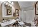 Cozy bathroom with a pedestal sink, toilet, framed mirror, and shower/tub combo at 1539 Old Town Ave., Georgetown, SC 29440