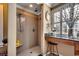 Modern bathroom with a walk-in shower, stool, decorative items, and tiled walls with a decorative vase at 1539 Old Town Ave., Georgetown, SC 29440