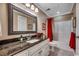 Bathroom features a granite countertop, a large mirror, and a shower-tub combination with a red shower curtain at 1539 Old Town Ave., Georgetown, SC 29440