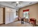 Comfortable bedroom with built-in wardrobe, ceiling fan, window, and two chairs at 1539 Old Town Ave., Georgetown, SC 29440