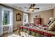 Bright bedroom featuring natural light, a bed with patterned quilt, and wooden furniture, creating a cozy retreat at 1539 Old Town Ave., Georgetown, SC 29440