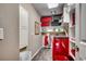 Laundry room features a bright red washer/dryer unit and storage for linens, laundry supplies, and suitcases at 1539 Old Town Ave., Georgetown, SC 29440