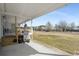 A covered back porch with a grill overlooks the yard for outdoor enjoyment at 1651 Circle Bay Dr., Longs, SC 29568