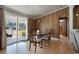 Dining room features wood paneling, wood furniture, and a sliding glass door to the outdoor covered patio at 1651 Circle Bay Dr., Longs, SC 29568