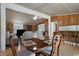 Dining room with vintage wood table and chairs, and a breakfast bar overlooking a modern kitchen and living room at 1651 Circle Bay Dr., Longs, SC 29568