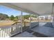 Inviting front porch with white railings and open views of the expansive front yard and blooming trees at 1651 Circle Bay Dr., Longs, SC 29568