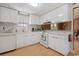 The updated kitchen is all white with a matching backsplash, a modern feel, and stainless steel appliances at 1651 Circle Bay Dr., Longs, SC 29568