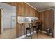 Kitchen bar with seating that looks into a modern, all white kitchen, including an updated fridge at 1651 Circle Bay Dr., Longs, SC 29568